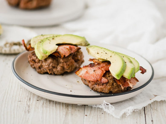 This Paleo avocado bacon burger recipe uses fresh seasonings for a juicy, flavorful burger topped with crisp bacon and creamy avocado.